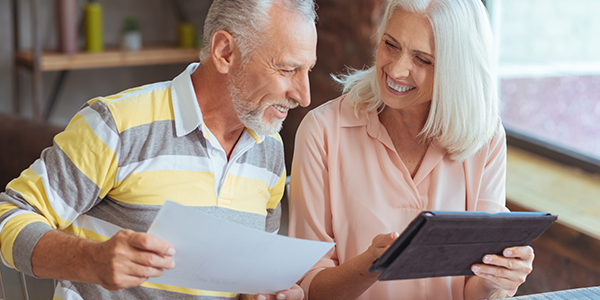 Couple happily viewing retirement accounts